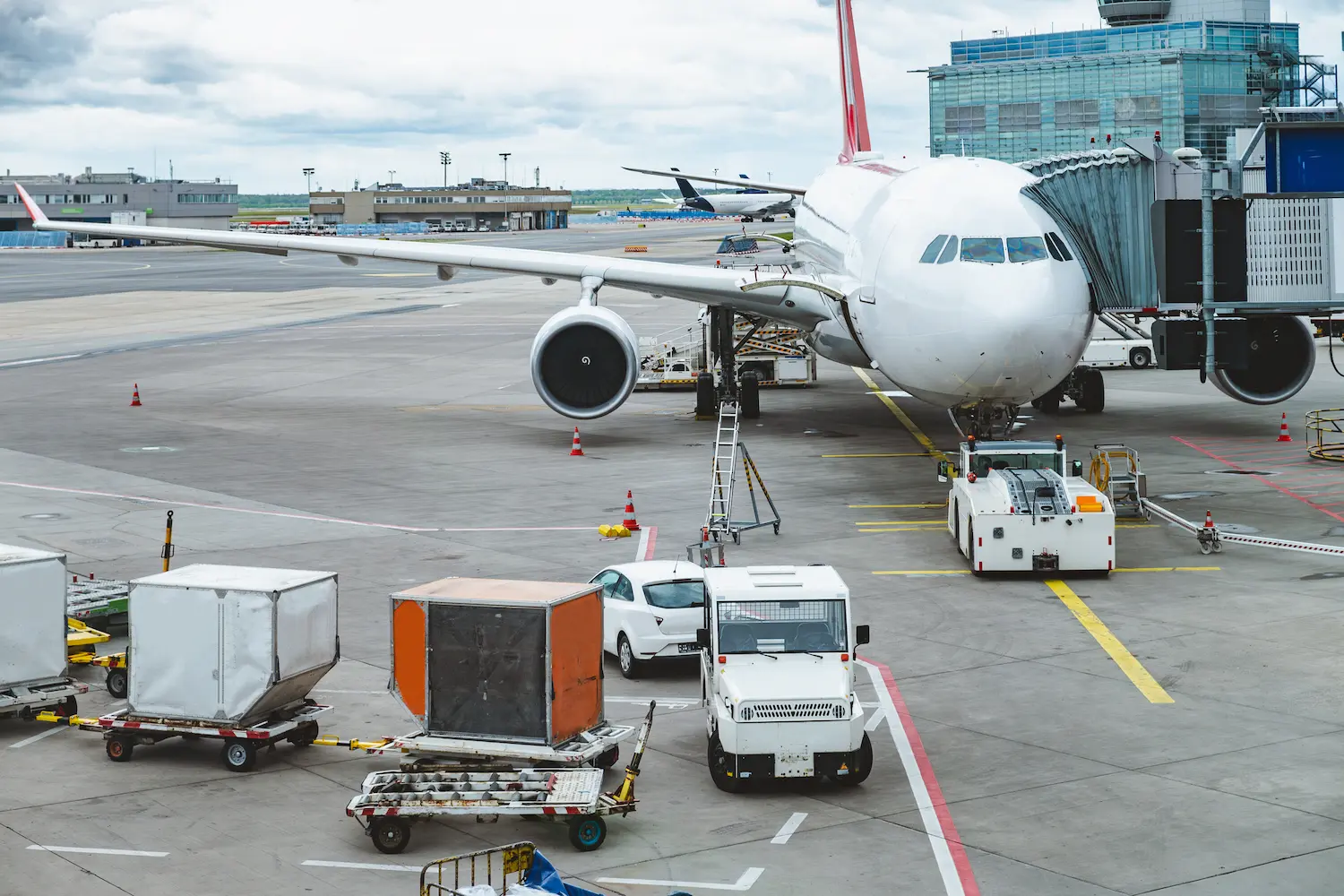 Airplane at gate with trucks